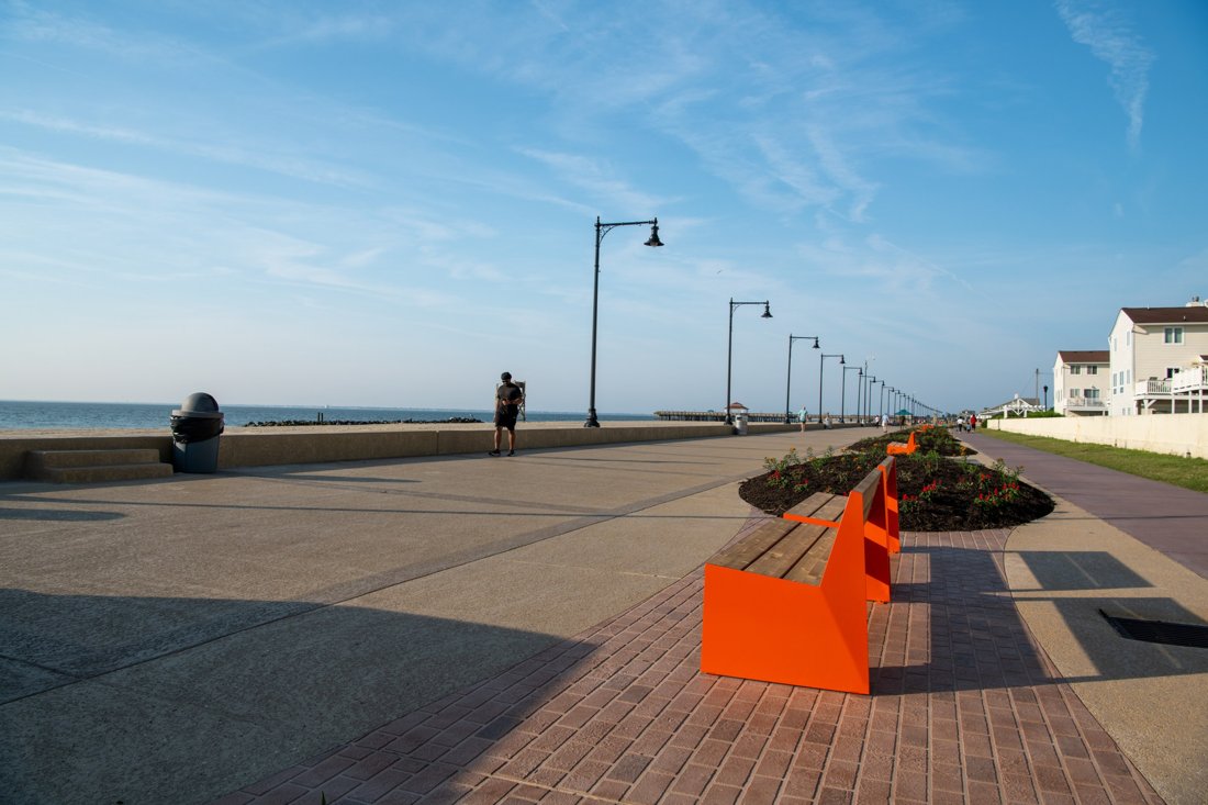 Finished boardwalk and seawall coatings with new seating beside existing pavers