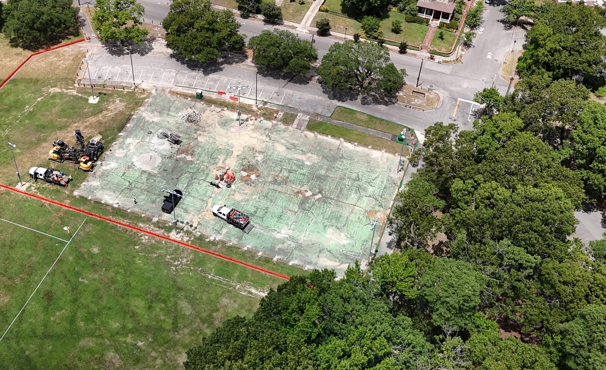 An early construction aerial shows demolition underway within the original court footprint.