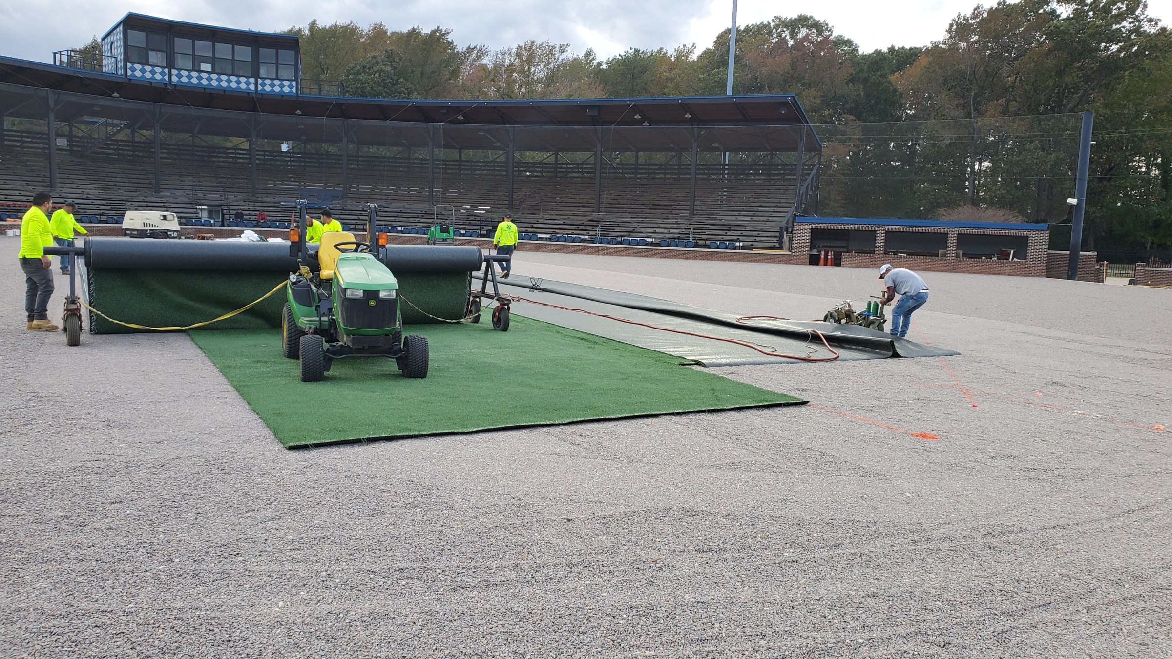 Turf installation follows the completed base preparation.