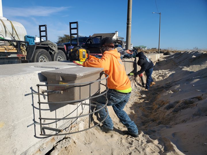 Reinforcement cage and conduit beside the seawall before concrete placement