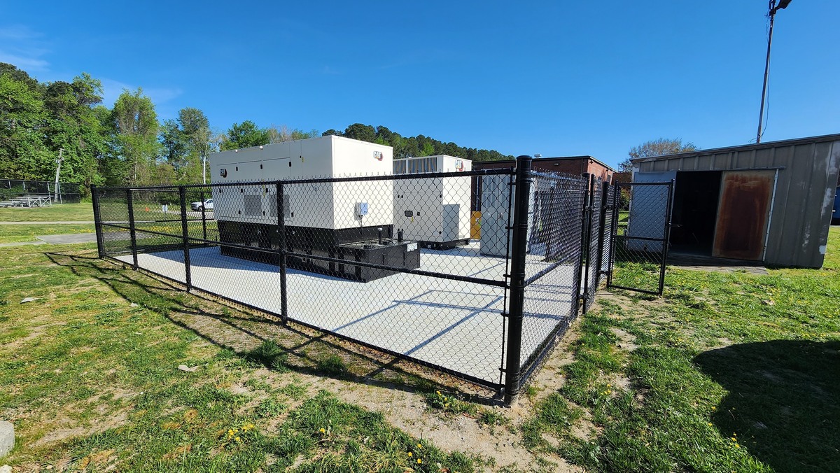 After: generator and fenced concrete pad