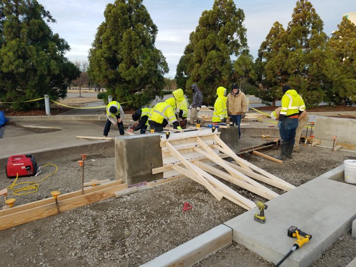 Crews assembling custom formwork for architectural concrete