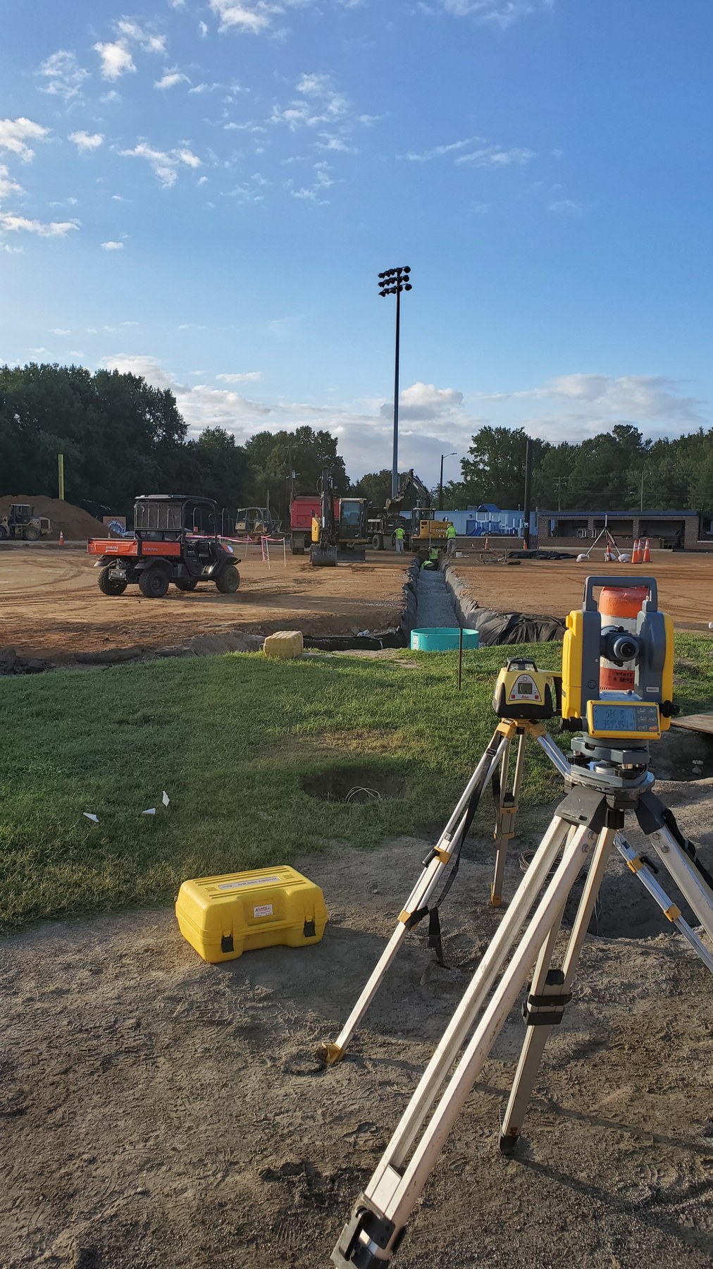 Field measurements guide the preparation beneath the playing surface.
