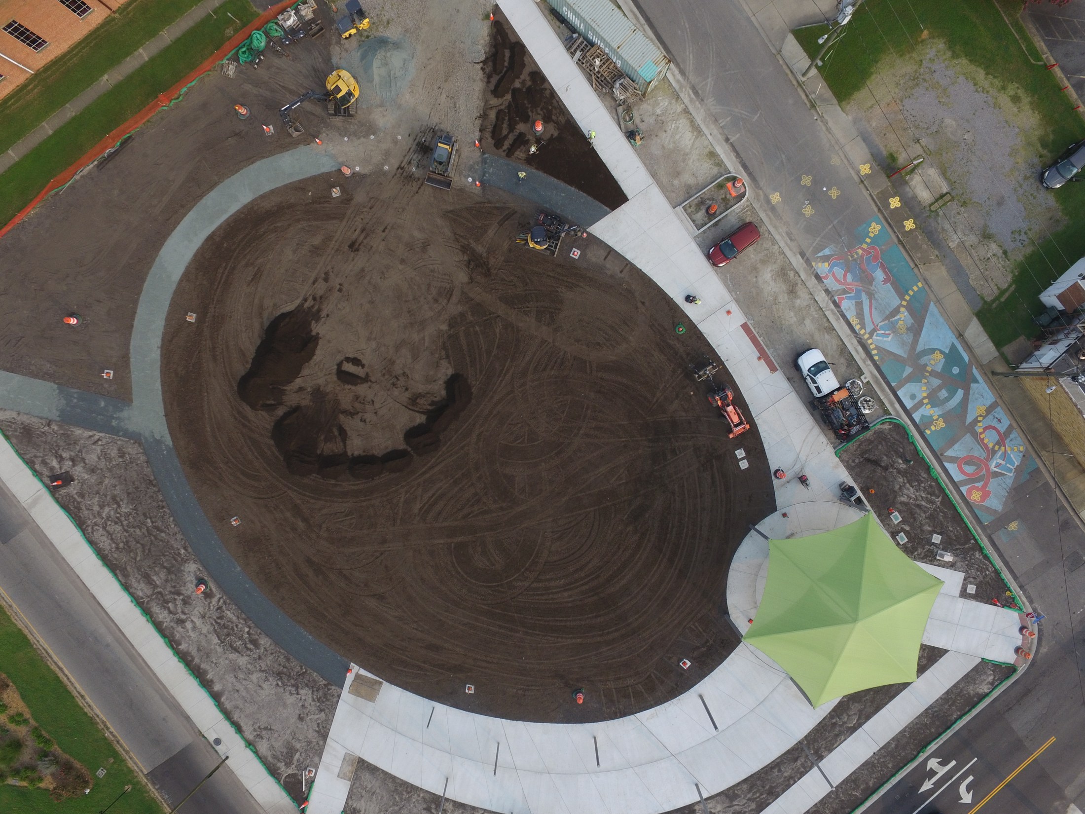 An earlier aerial shows earthwork and the developing path network before the lawn was established.
